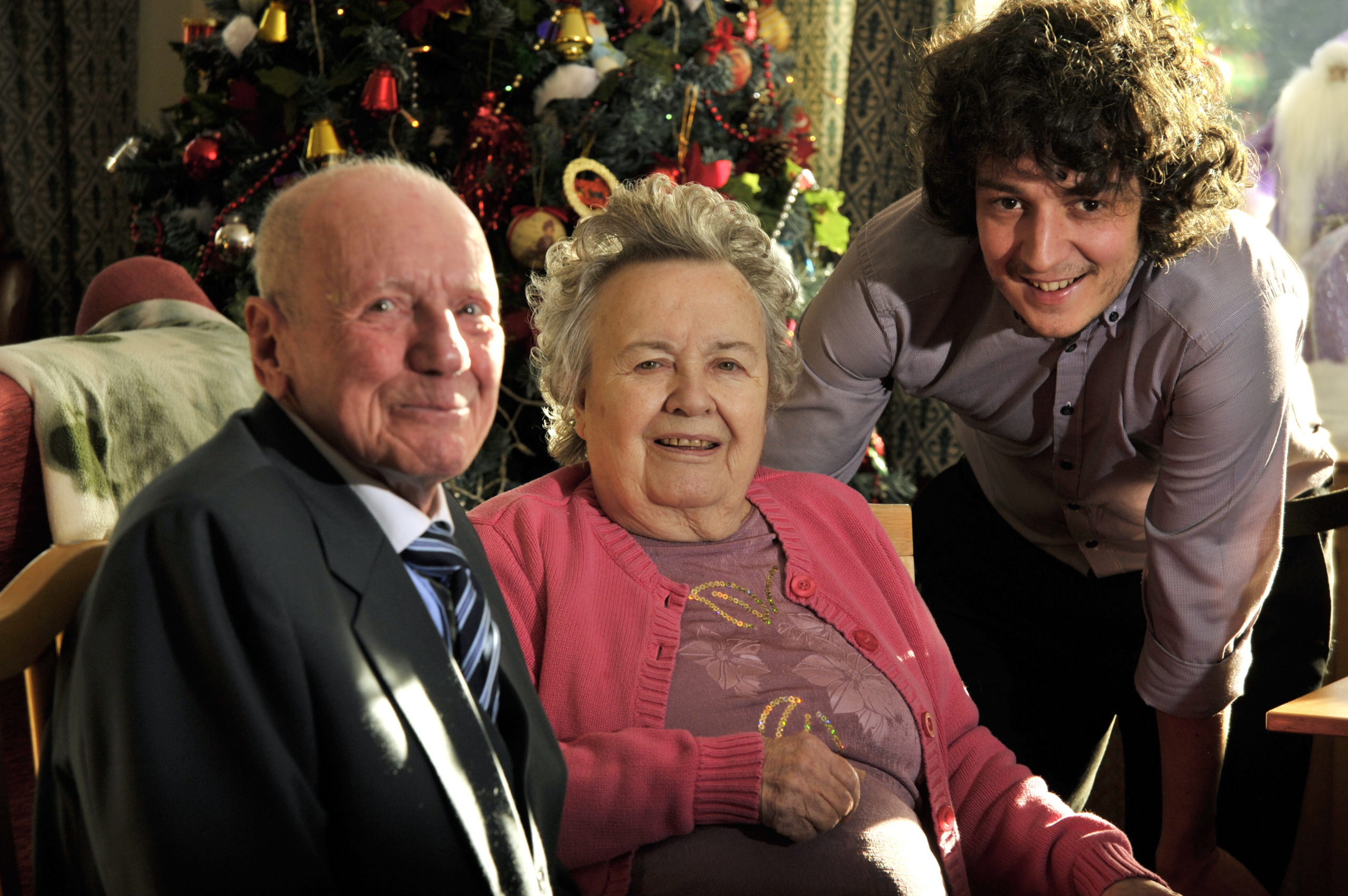 Pictures at Taliesin residential home, Bridge Street, Tonypandy. Assistant manager Tom Thatcher, right, chats to Ken Owen,aged 81, left, and Cecilia-Mary Owen, aged 81, middle.