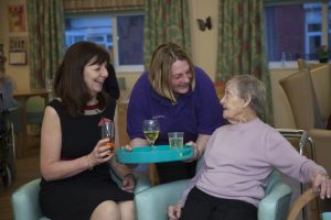 Pendine Park... Lesley Griffiths AM visits the Hillbury Pop up pub. Pictured is Lesley Griffiths AM with Anita Moran Hillbury House activities co-ordinator and   resident Cissie Hilton.