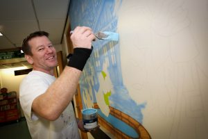  Artist Gary Drew creating pirate-themed giant artworks at the entrance to the Children’s Department.