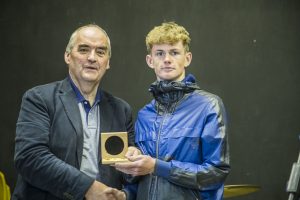 Gwynfor Jones of Pendine Park presents medal to Ryan Cain winner of the 10k race