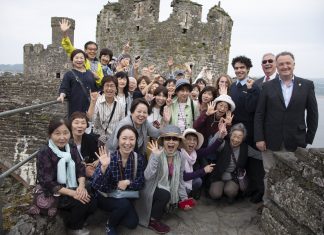 North Wales Tourism Pictured (right ) are Jim Jones, MD of North Wales Tourism Ltd in Llanduddno, ex Mayor of Conwy Cllr Bill Chapman, Leith Jawzi and Lauren Lewsley from CADW with some Japanese tourists.