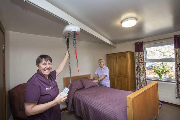 Cariad Care Homes, Porthmadog, investment. Pictured are Jill Jones and Monica Stevenson with one of the new hoists.