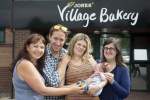 Village Bakery staff meet Baby Tao James Cooke and his parents Matt Cooke and Margaret Edwards; Pictured are Michelle Taylor Jones, Matt Cooke, Margaret Edwards and Jeanette Owens with Baby Tao James Cooke.