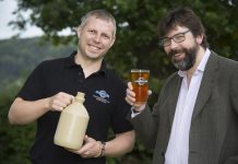 Ynyr Evans a brewer at Llangollen brewery with the special brewed beer to celebrate the 20th anniversary of the llangollen food festival. Pictured are Ynyr Evans from Llangollen Brewery with Llangollen food festival committee member Pip Gale.