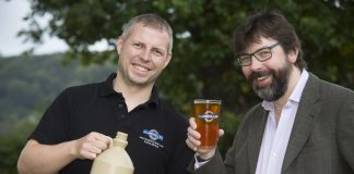 Ynyr Evans a brewer at Llangollen brewery with the special brewed beer to celebrate the 20th anniversary of the llangollen food festival. Pictured are Ynyr Evans from Llangollen Brewery with Llangollen food festival committee member Pip Gale.